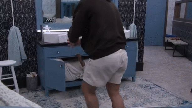Matt sliding Felicia out of the cupboard